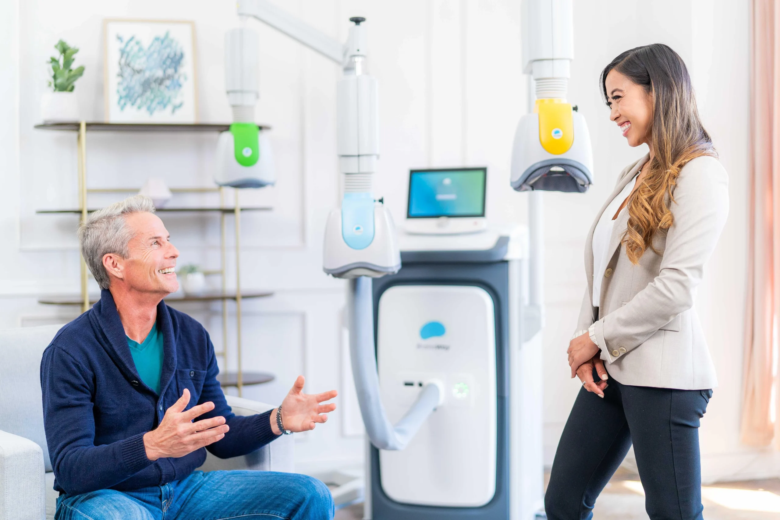 Man discussing TMS treatment with woman